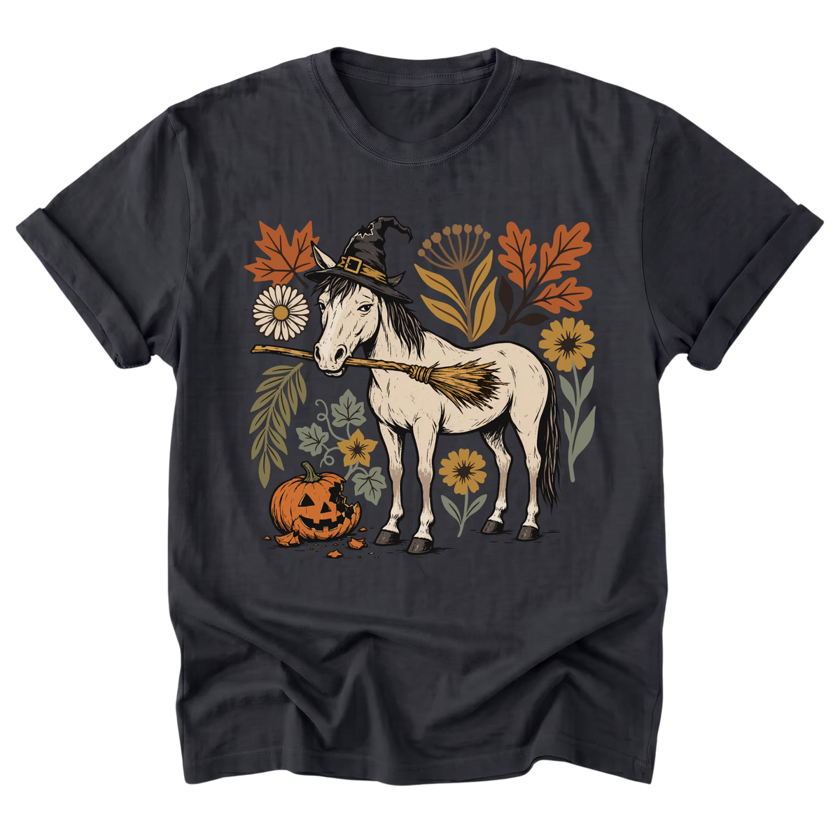 A black t-shirt featuring a detailed graphic of a white horse dressed as a witch with a broomstick, surrounded by autumn leaves, flowers, and a jack-o'-lantern pumpkin.