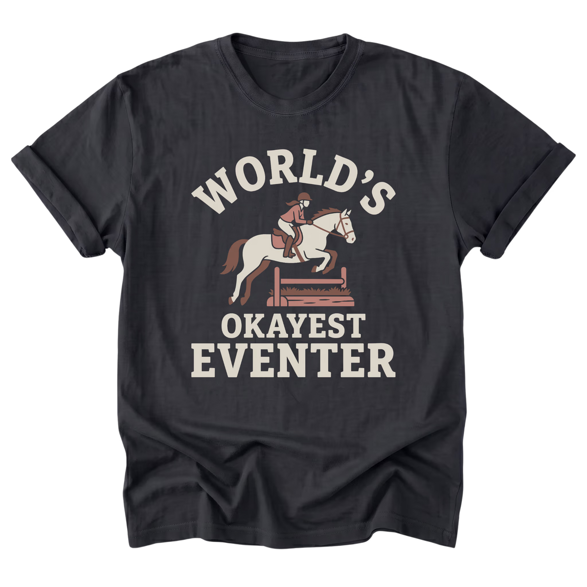 A black t-shirt with a vintage-style graphic print featuring a horse and rider jumping a hurdle, with the text 'WORLD'S OKAYEST EVENTER' in cream and muted red-brown tones.