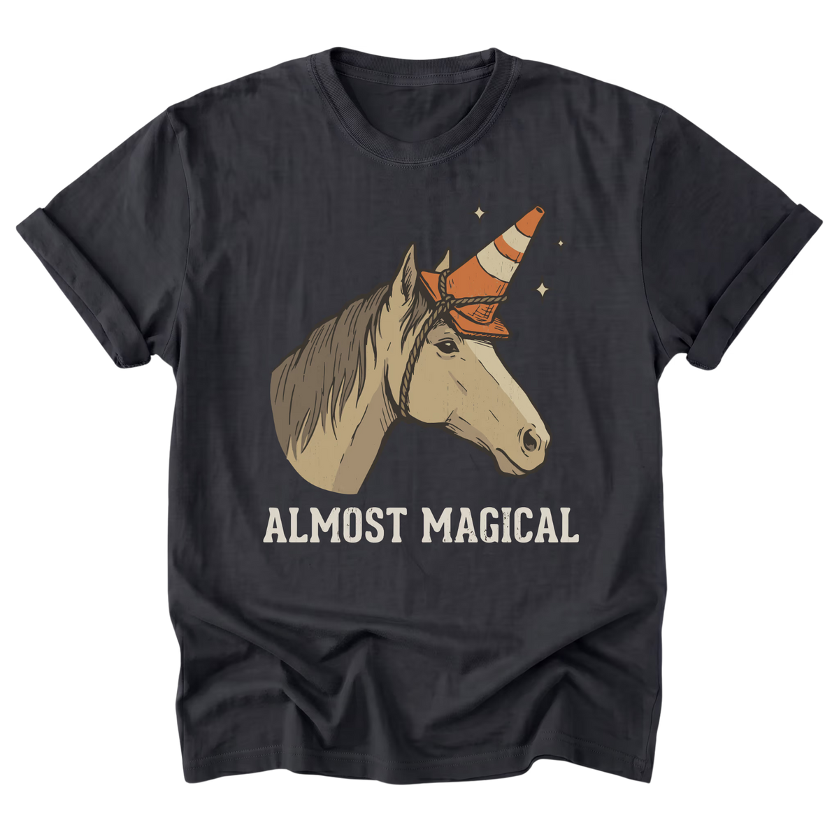 A black t-shirt featuring a graphic of a beige horse with a traffic cone as a horn, above the text 'ALMOST MAGICAL' in cream. The t-shirt is shown flat against a solid white background.