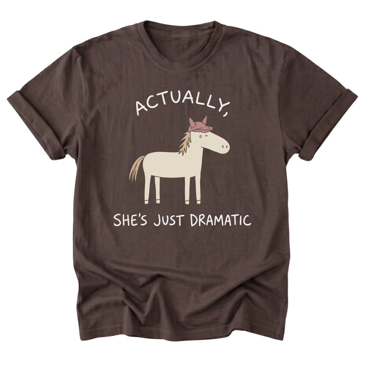 A dark brown short-sleeve t-shirt with a graphic of a cartoon horse wearing a pink crown, accompanied by the text 'ACTUALLY, SHE'S JUST DRAMATIC' in white.