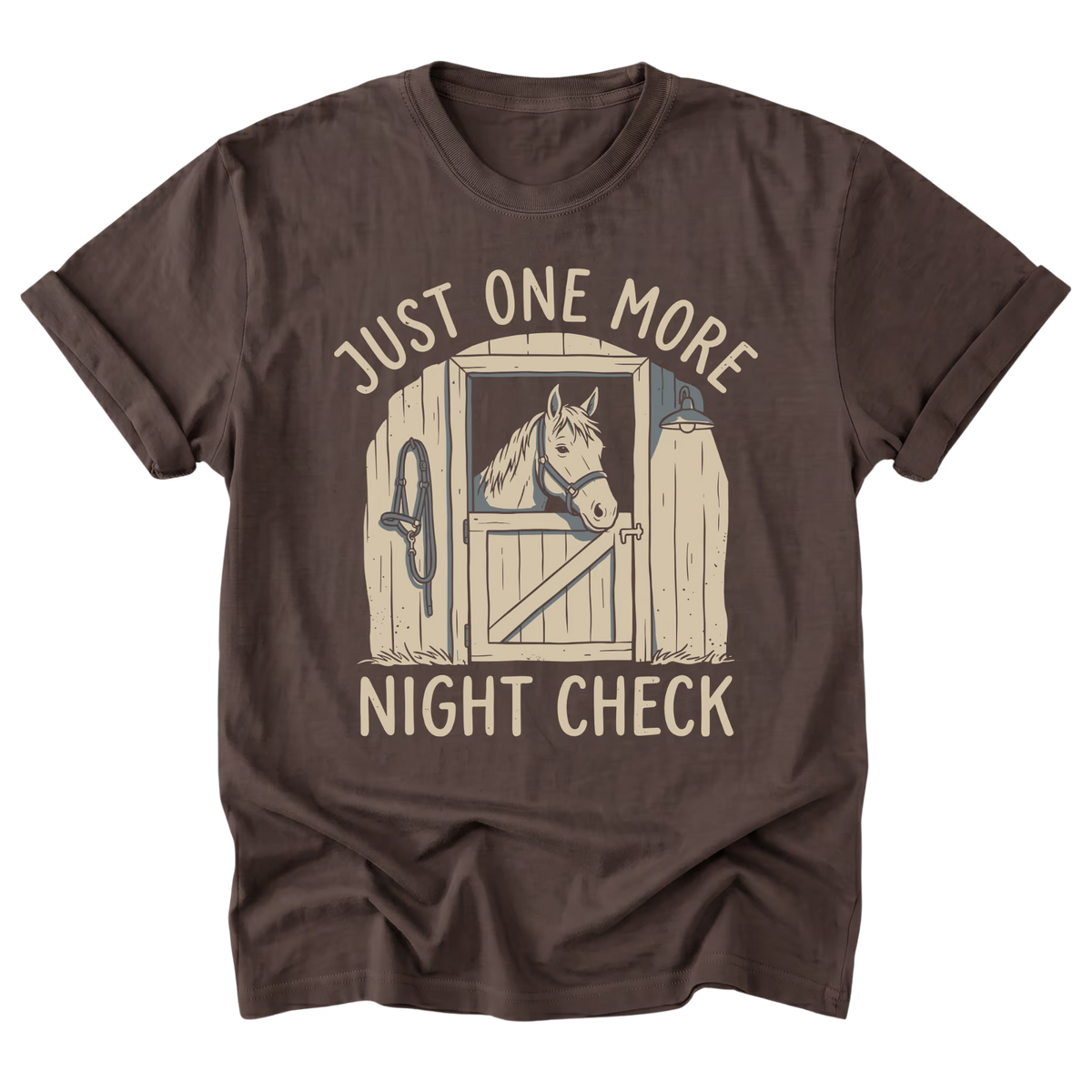 A dark brown short-sleeve t-shirt with a graphic of a horse in a stable door and the text 'JUST ONE MORE NIGHT CHECK' printed in a distressed cream font.