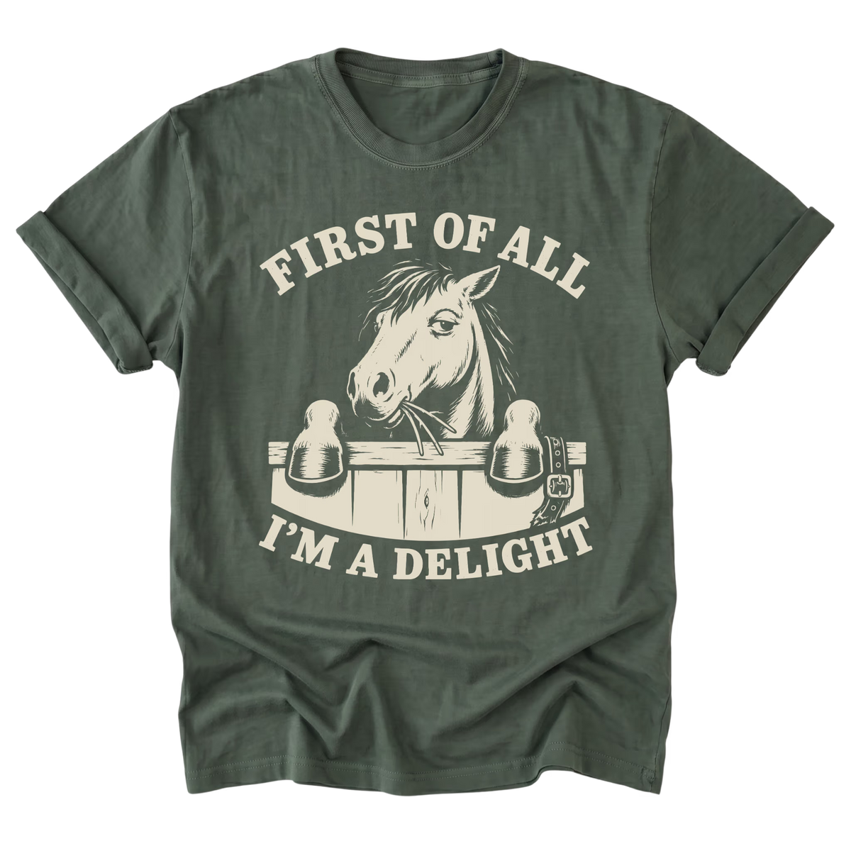An military green short-sleeve t-shirt with a vintage-style cream graphic of a horse at a stable gate and the text 'FIRST OF ALL I'M A DELIGHT'.
