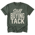 A military green t-shirt with a distressed off-white graphic text reading 'Still BUYING TACK' on the front, displayed against a solid white background.