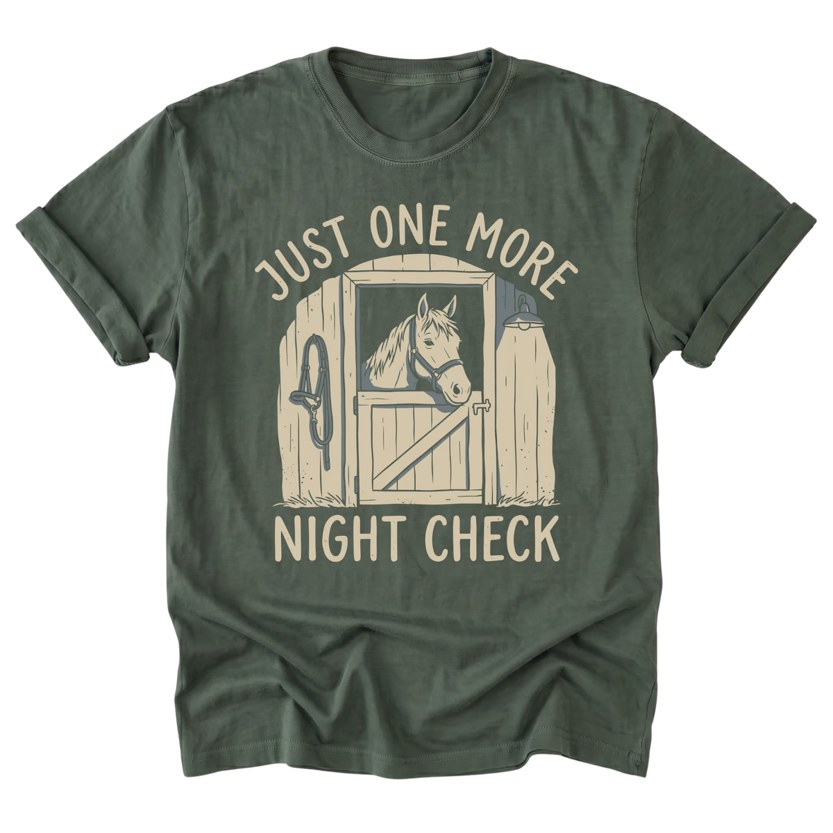 A military green short-sleeve t-shirt with a graphic print of a horse in a stable door and the text 'JUST ONE MORE NIGHT CHECK' in a light beige color, displayed on a solid white background.