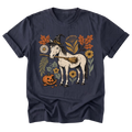 A navy blue short-sleeve t-shirt with a graphic print of a white horse wearing a witch hat and broom, surrounded by autumn leaves, flowers, and a jack-o'-lantern pumpkin, shown on a plain white background.