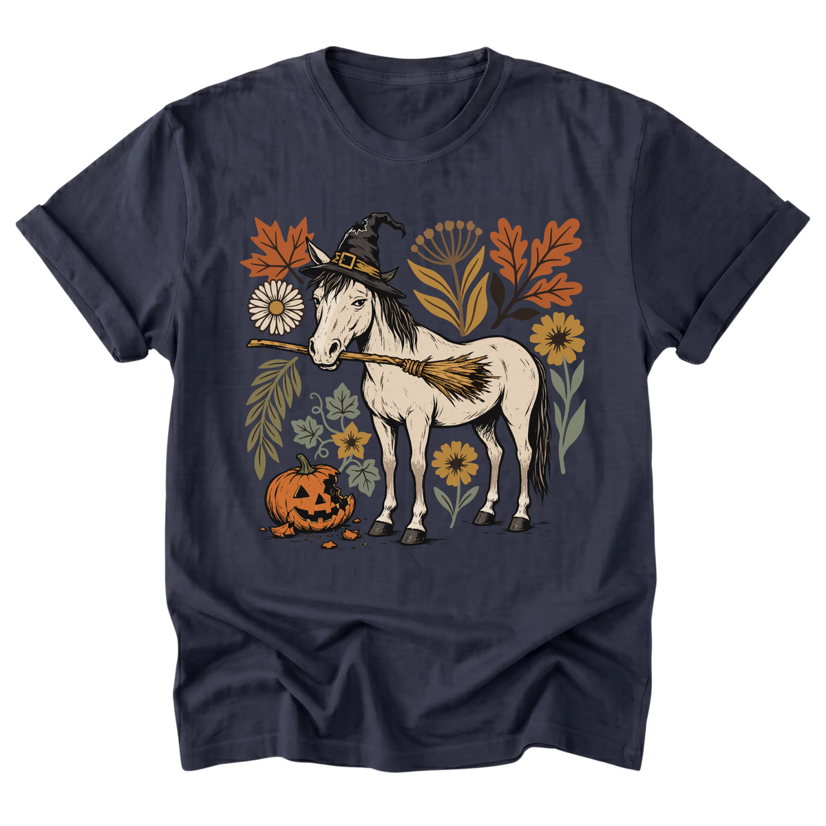 A navy blue short-sleeve t-shirt with a graphic print of a white horse wearing a witch hat and broom, surrounded by autumn leaves, flowers, and a jack-o'-lantern pumpkin, shown on a plain white background.