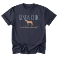 A navy blue short-sleeve t-shirt with a graphic print on the front. The print features the text 'KINDA CHIC' in a dusty blue-gray font, a tan horse silhouette in the center, and 'to be horse obsessed' in a light beige font below it.