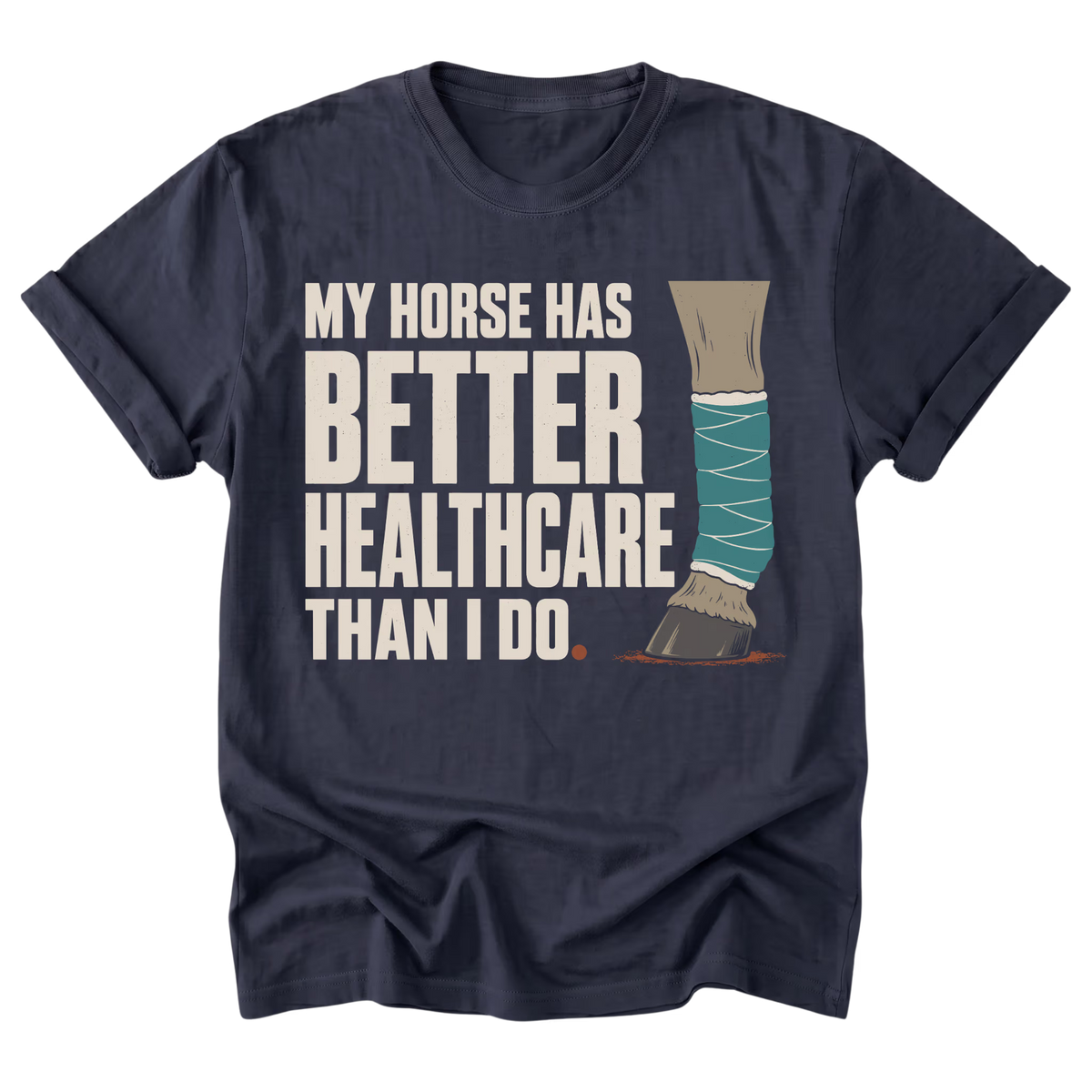 A navy blue short-sleeve t-shirt with a graphic print that reads 'MY HORSE HAS BETTER HEALTHCARE THAN I DO' next to an illustration of a horse leg wrapped in teal bandages and a brown hoof, shown on a plain white background.