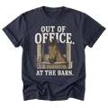 A navy blue short-sleeve t-shirt with a graphic print of a brown horse in a stable doorway and the text 'OUT OF OFFICE. AT THE BARN.