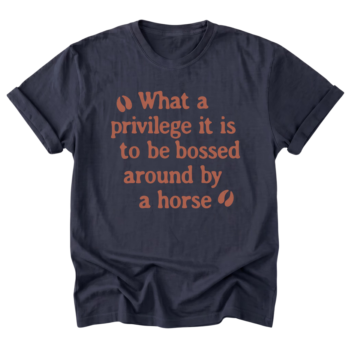 A navy blue short-sleeve t-shirt with a warm orange graphic text print on the front that reads 'What a privilege it is to be bossed around by a horse' flanked by two small leaf icons, displayed on a clean white background.