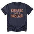 A navy blue t-shirt featuring the text 'KINDA CHIC TO BE A HORSE GIRL' printed on the front.
