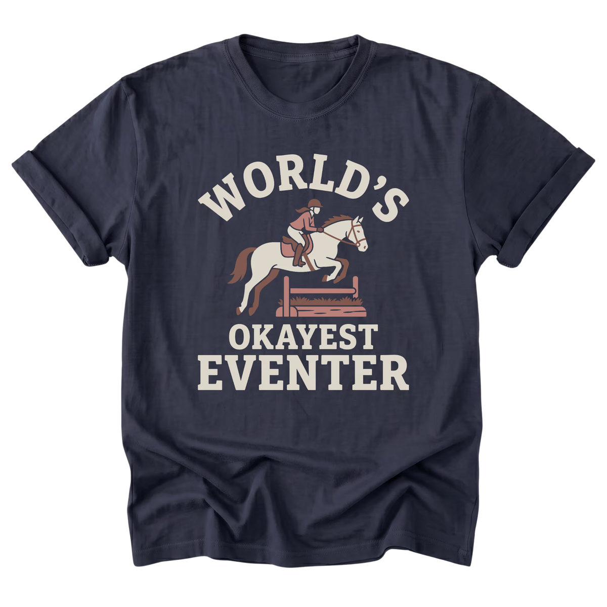 A navy blue short-sleeve t-shirt with a vintage-style graphic on the front. The graphic features a white horse with a rider jumping over a wooden fence, with the text 'WORLD'S OKAYEST EVENTER' printed in white and light brown.