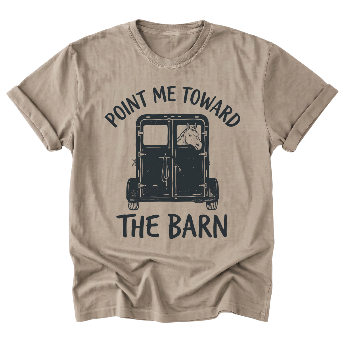 A sand beige crewneck t-shirt with a graphic print of a horse in a barn and the text 'POINT ME TOWARD THE BARN' in dark navy blue, displayed on a clean white background.