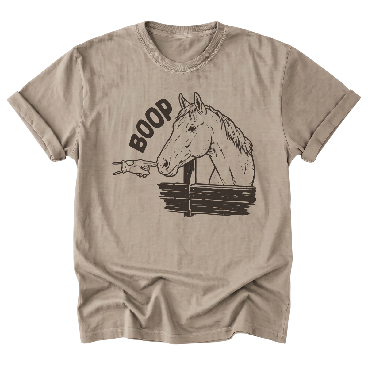 A sand beige graphic t-shirt featuring an illustration of a horse and gloved hand booping the muzzle of the horse and heaturing the text 'BOOP' printed on the front.