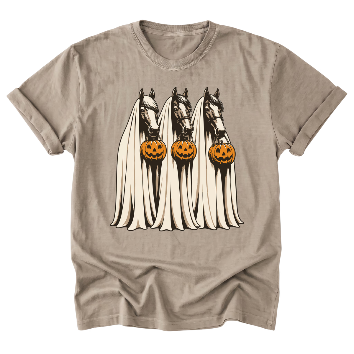 A sand beige crewneck t-shirt featuring a graphic of three horses draped in white ghostly sheets, each holding a carved orange pumpkin, shown on a plain white background.