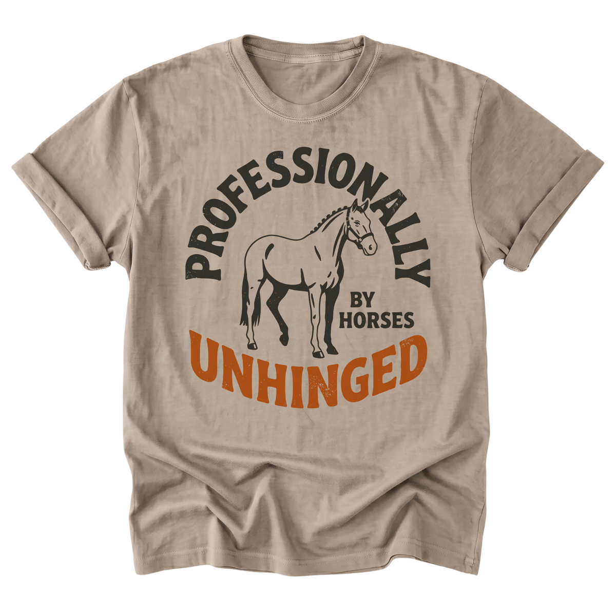 A sand beige crewneck t-shirt with a graphic print featuring a horse illustration and the text 'PROFESSIONALLY UNHINGED BY HORSES' in black and orange, displayed on a clean white background.