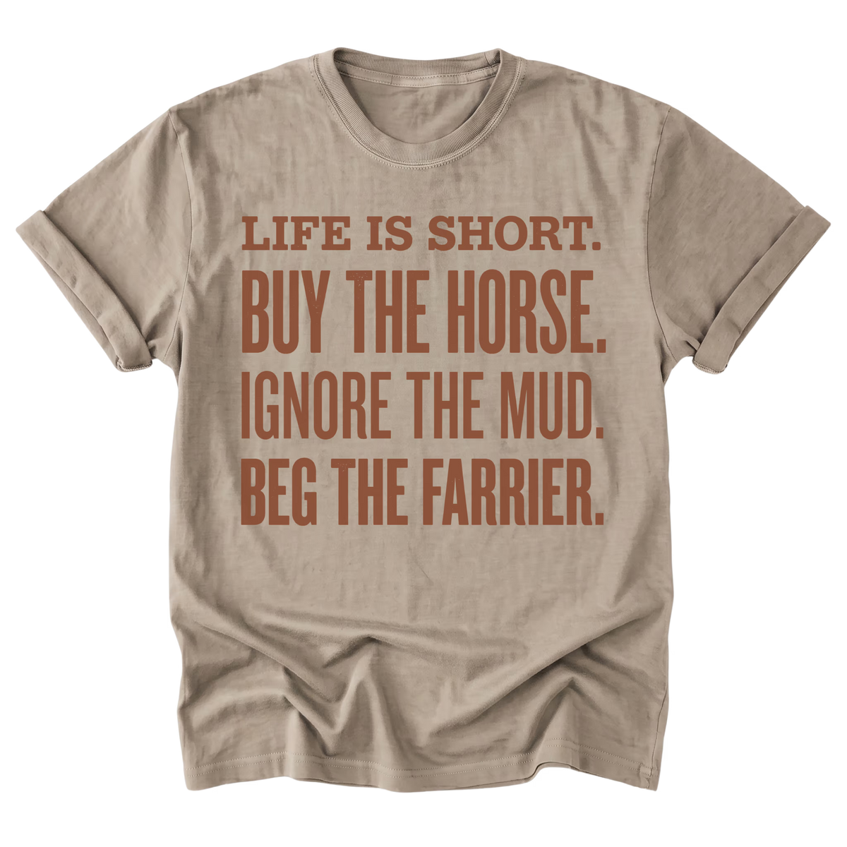 A beige sand short-sleeve t-shirt with a brown printed text graphic on the front that reads 'LIFE IS SHORT. BUY THE HORSE.