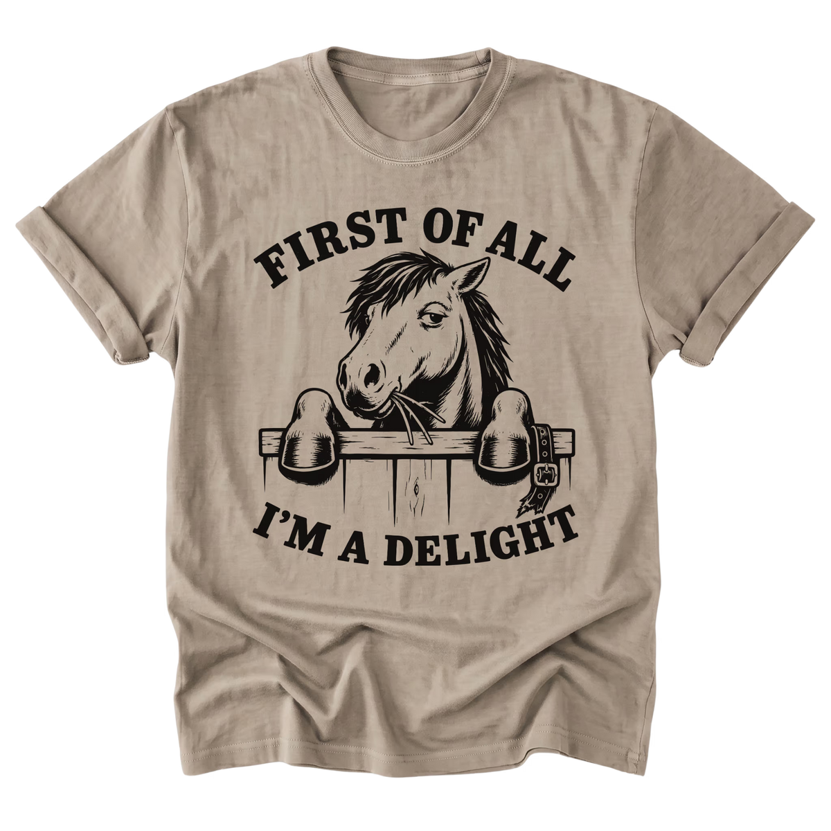 A sand beige crewneck t-shirt with a black graphic print of a horse behind a fence and the text 'FIRST OF ALL I'M A DELIGHT'.